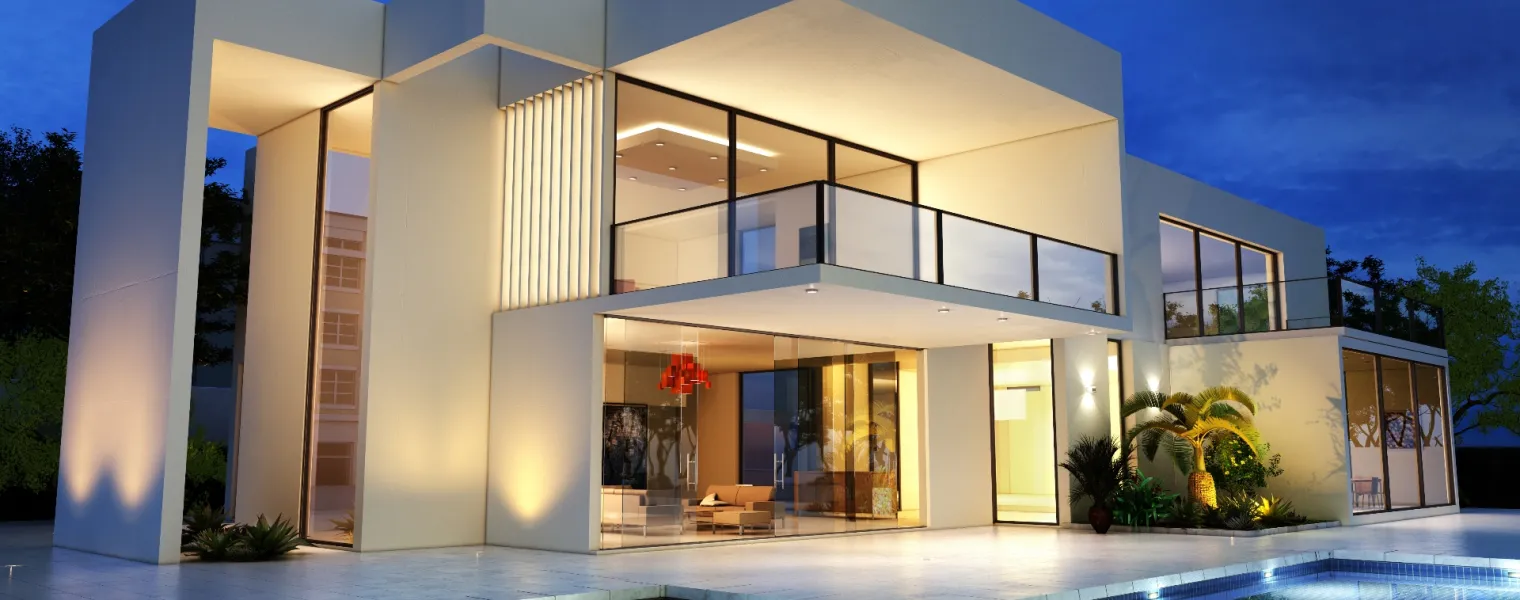 Eine moderne Villa mit Pool bei Nacht.